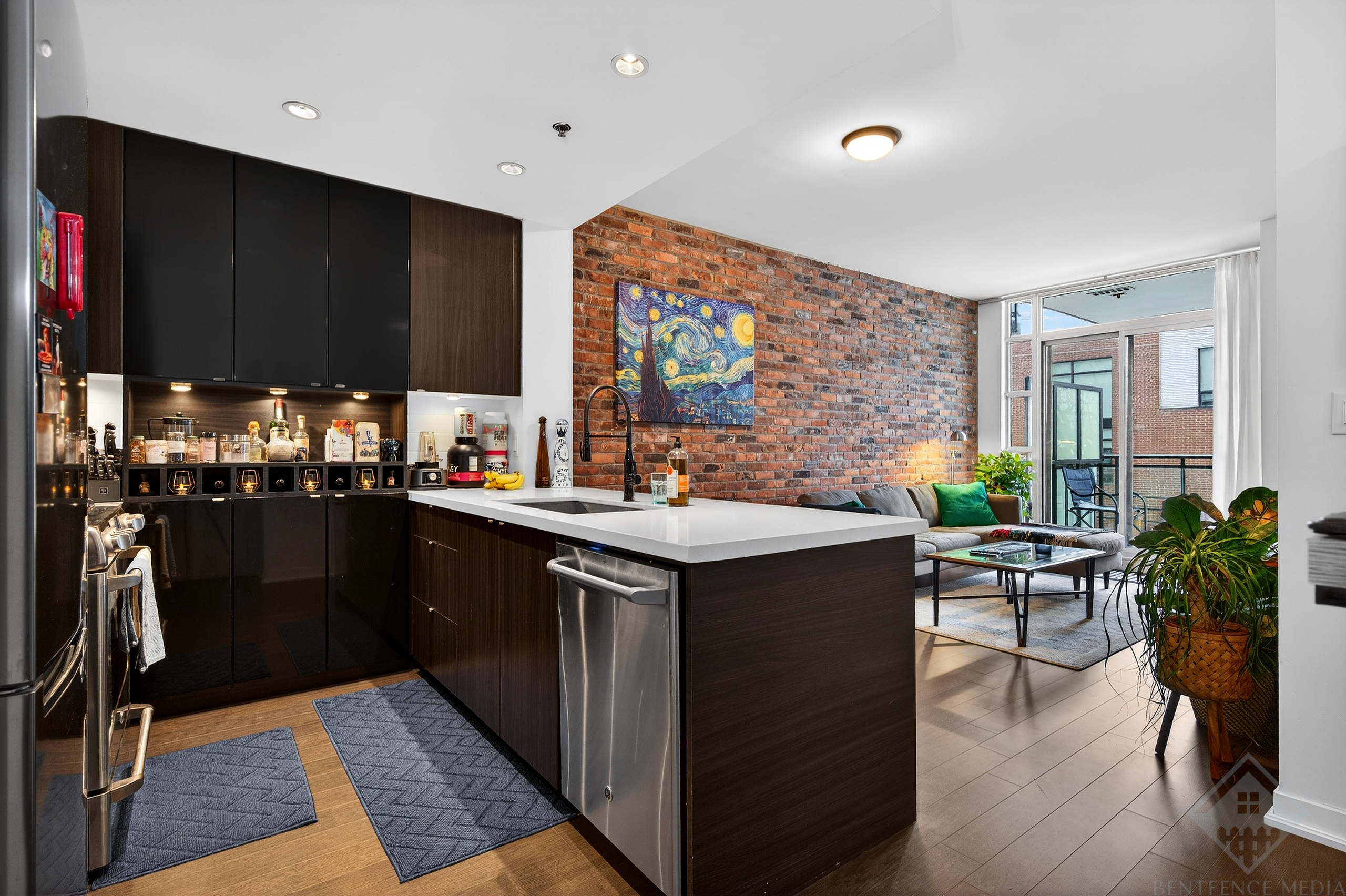 Modern Toronto condo living room with exposed brick wall and hardwood floors